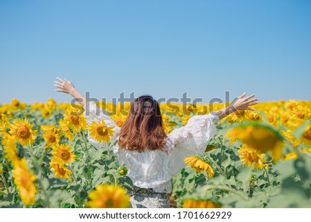 Beautiful asian girl in sunflower field. Happy young woman in sunflower field. Portrait of asian woman in sunflower field when traveling on vacation. Royalty-Free Stock Photo #1701662929