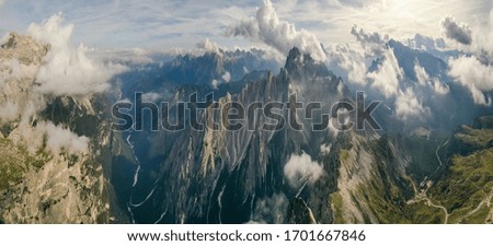 Italian Dolomites, Tre Cime - Rifugio Lavaredo - stony road around Tre Cime .Peak in the clouds. Aerial shot.