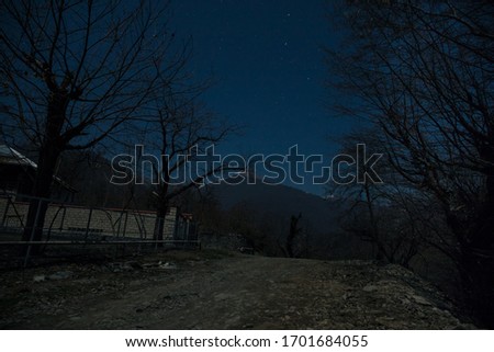 Full moon over quiet village at night. Beautiful night landscape of mountain village under the moonlight. Azerbaijan nature. Long exposure shot
