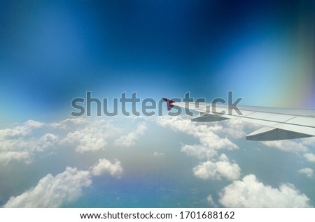 Beautiful view of the airplane wing and the evening sky with clouds. Background of air travel and tourism