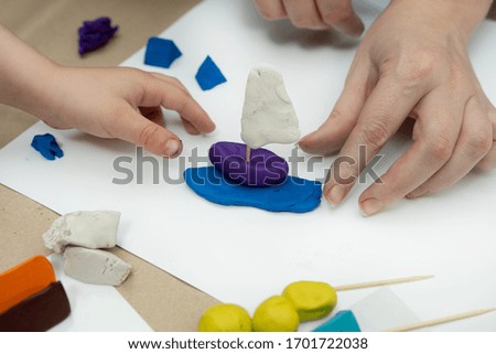 children's plasticine crafts - sailboat. occupation with a child