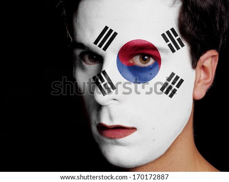 Flag of South Korea Painted on a Face of a Young Man