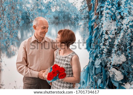 Beautiful elegant middle-aged couple posing smiling at a holiday.