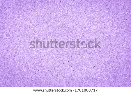 Texture of bright lilac rough paper with fibers. Eco-recycled kraft paper. Cardboard background.
