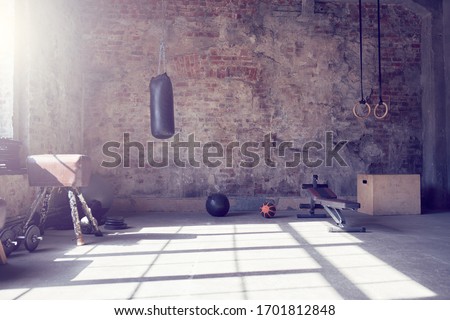 Loft style gym with old brick wall with sports equipment