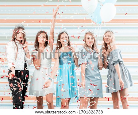 Happy girls at birthday party with balloons and confetti