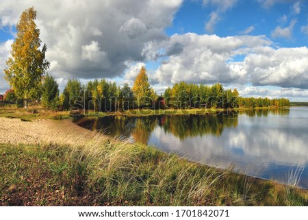 Autumn trees on the banks of a beautiful forest lake. Royalty-Free Stock Photo #1701842071