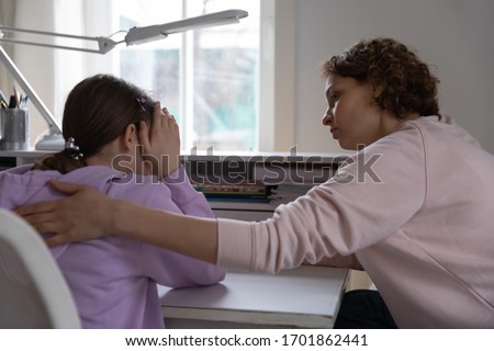 Worried young mother talking comforting upset teen daughter helping with problem or apologizing at home. Caring parent mum consoling depressed adolescent child giving psychological support concept. Royalty-Free Stock Photo #1701862441