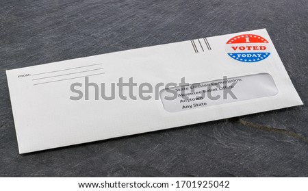 Envelope containing voting ballot papers being sent by mail for absentee vote in presidential election Royalty-Free Stock Photo #1701925042