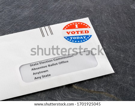 Envelope containing voting ballot papers being sent by mail for absentee vote in presidential election Royalty-Free Stock Photo #1701925045