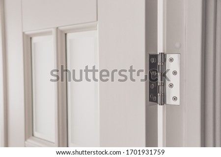 stainless door mortised hinge on a white door Royalty-Free Stock Photo #1701931759