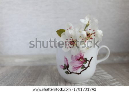 Blooming branch in a cup