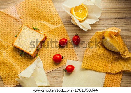 Top view handmade recycable beeswax wraps on wooden surface Royalty-Free Stock Photo #1701938044