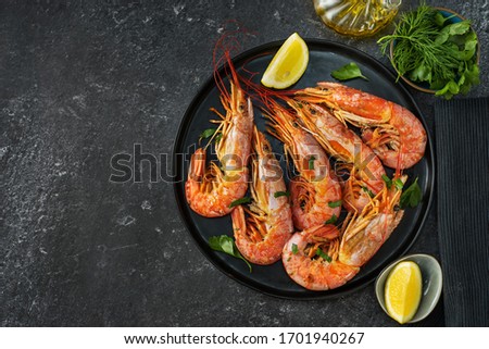Top view of dining table with red big prawns and coocking ingredients Royalty-Free Stock Photo #1701940267