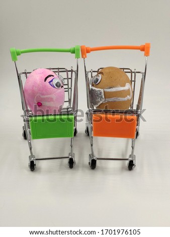 Easter eggs (a girl and a boy) wearing medical masks met on grocery carts.
