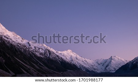 Mountain range with snowy peaks shot during sunrise, made in Aoraki Mt Cook National Park, New Zealand