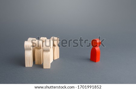 Red figurine person and crowd of people standing separately. Leader and leadership skills. Cooperation, collaboration. Fear estrangement from infected. Isolation, avoidance of direct contact. Mistrust Royalty-Free Stock Photo #1701991852