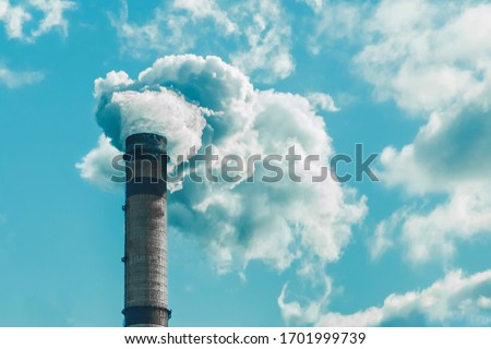 Environmental pollution, environmental problem, smoke from the chimney of an industrial plant or thermal power plant against a cloudy sky Royalty-Free Stock Photo #1701999739