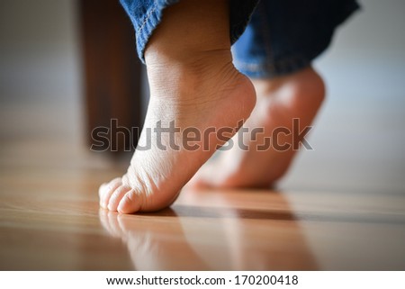 Infant Child's Feet On Tippy Toes - Innocence Concept Royalty-Free Stock Photo #170200418