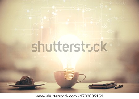 Double exposure of light bulb hologram over coffee cup background in office. Concept of idea