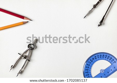 pencil rulers and protractor on the table as items for students and engineers