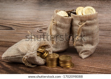 sack bag with Malaysia Ringgit coin on wooden table.- Saving Concept