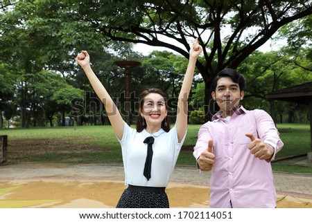 young asian malay chinese man woman outdoor park walk stand study talk discuss laptop file book backpack pose happy joy thumbs up