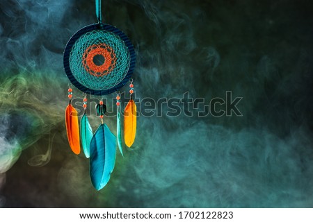 Bright dreamcatcher on dark abstract background Royalty-Free Stock Photo #1702122823