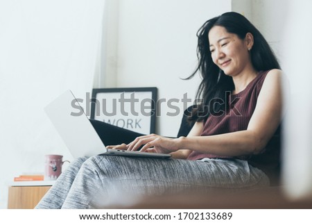 work from home.using computer.hand typing keyboard laptop online chatting search form internet while working sitting on sofa.concept for technology device contact communication business people