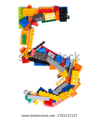 Arabic numeral "5"  from multi-colored children's plastic constructor on a white isolated background.  Bright alphabet for kids design