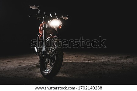 Moto under back lit light, black background