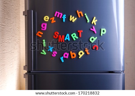 Word Smart spelled out using colorful magnetic letters on refrigerator