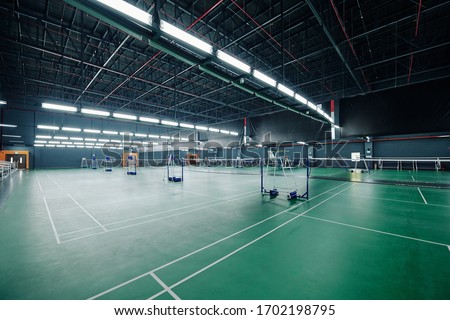 Spacious empty gymnasium for tennis and badminton tournaments Royalty-Free Stock Photo #1702198795