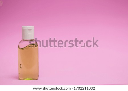 antiseptics bottle on a pink background