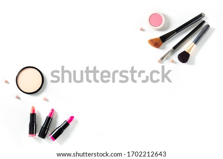 Professional makeup on a white background. Brushes, lipstick and other products, a flat lay with copy space, a design template