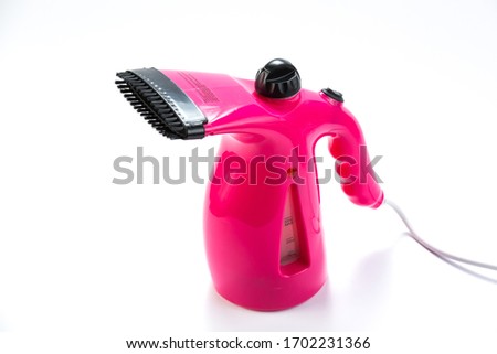 Garment steamer, pink portable iron for home isolated on white background