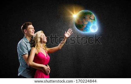 Conceptual image of young couple hugging each other and dreaming. elements of this image are furnished by NASA