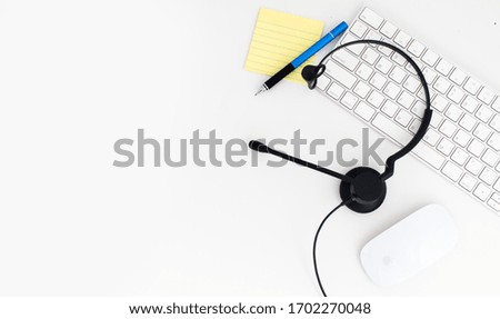VOIP headset on laptop computer keyboard. Communication support for callcenter and customer service Helpdesk. Isolated on white background. top view flat lay background. Space for text design