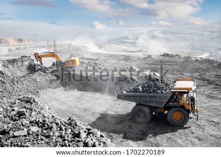 Open pit mine industry, big yellow mining truck for coal anthracite. Royalty-Free Stock Photo #1702270189