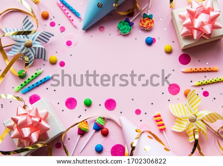 Happy birthday or party background.  Flat Lay wtih birthday balloons , confetti and ribbons on pink background. Top View.  Copy space.