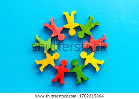Tolerance, social protection, anti-discrimination concept. Wooden human figures on blue table, top view