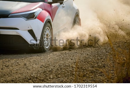Rally racing car on dirt road. Royalty-Free Stock Photo #1702319554