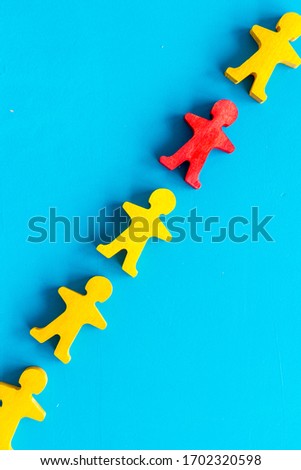 Wooden figures of people on blue background top view. Teamwork, teambuilding concept