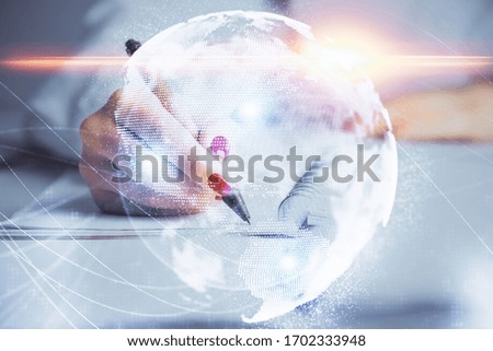 International business hologram over hands taking notes background. Concept of success. Multi exposure