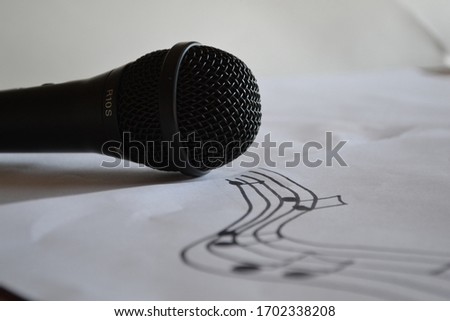 Music notes coming out of microphone on a white background