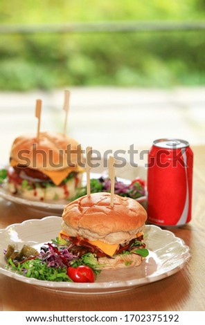 Hamburgers with a drink on the table. Royalty-Free Stock Photo #1702375192