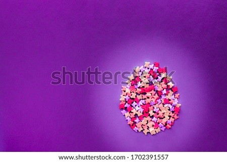 Easter egg made of colored sprinkles for Easter cakes on a soft background