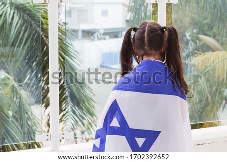 jewish girl celebration "yom hazikaron" and "yom haatzmanut" israeli independece day and memory day concept. stay at home. israel flag