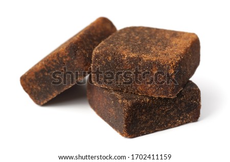 dark brown sugar cubes isolated on the white background Royalty-Free Stock Photo #1702411159