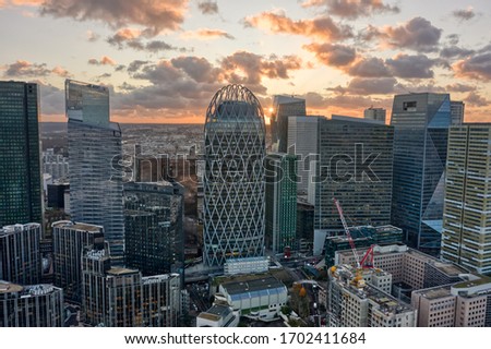 Aerial drone shot of La Defense business district skyscrapers in Paris during sunset